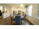 Dining area right off the kitchen with a woven light fixture and natural light at 100 E Delafield Ave, Durham, NC 27704