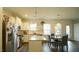 Open-concept kitchen featuring stainless steel appliances, an island, and seamless flow to the dining area at 100 E Delafield Ave, Durham, NC 27704