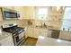 Updated kitchen with granite countertops, stainless steel appliances, and ample cabinet space at 100 E Delafield Ave, Durham, NC 27704
