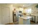 Bright kitchen with stainless steel appliances, island, and plenty of cabinet space at 100 E Delafield Ave, Durham, NC 27704