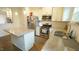 Kitchen island with stainless steel appliances, countertops and cabinetry at 100 E Delafield Ave, Durham, NC 27704