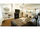 Cozy living room with a fireplace, built-in shelving, and an open layout at 100 E Delafield Ave, Durham, NC 27704