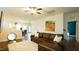 Open-concept living room with a leather sofa and views of the kitchen and dining area at 100 E Delafield Ave, Durham, NC 27704