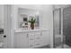 Bathroom featuring double sinks with a large mirror and a glass-enclosed shower with tile surround at 1005 Regalia Rd # 32, Durham, NC 27713