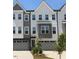 Charming townhome featuring a modern gray and white facade with attached garages and well-maintained landscaping at 1005 Regalia Rd # 32, Durham, NC 27713