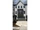 Modern townhome featuring a two-car garage and neutral-tone exterior with black trim and visible house number at 1005 Regalia Rd # 32, Durham, NC 27713