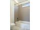 Modern bathroom featuring tile surround, small window, and white penny tile at 103 Inara Ct, Carrboro, NC 27510