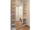 Organized closet with multiple shelves, hanging rod, and mirrored door at 103 Inara Ct, Carrboro, NC 27510