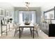Elegant dining room featuring a long table with seating for eight, stylish lighting, and sophisticated decor at 103 Inara Ct, Carrboro, NC 27510