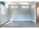 Bright empty room with gray walls, modern baseboards, and large windows at 103 Inara Ct, Carrboro, NC 27510