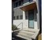 Welcoming front entrance with a modern door, sleek hardware, and manicured greenery at 103 Inara Ct, Carrboro, NC 27510