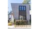 Modern home featuring a sleek gray facade with dark-framed windows and minimalist landscaping at 103 Inara Ct, Carrboro, NC 27510