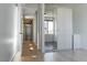 Bright hallway with hardwood floors leading to bedrooms and mirrored closet at 103 Inara Ct, Carrboro, NC 27510
