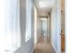 Bright hallway features hardwood floors, natural light, and access to ensuite bath and bedrooms at 103 Inara Ct, Carrboro, NC 27510