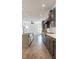 Modern kitchen flows to living room with stainless steel appliances and an open-concept design at 103 Inara Ct, Carrboro, NC 27510