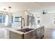 Spacious kitchen features a central island with stainless steel sink and marble countertop at 103 Inara Ct, Carrboro, NC 27510
