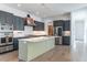 Modern kitchen featuring gray cabinetry, stainless steel appliances, and marble countertops at 103 Inara Ct, Carrboro, NC 27510