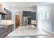 A modern kitchen featuring a marble island, stainless steel appliances, and hardwood flooring at 103 Inara Ct, Carrboro, NC 27510