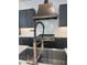 A stainless steel kitchen sink and modern faucet complement the tile backsplash and updated cabinets at 103 Inara Ct, Carrboro, NC 27510