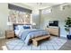 Sunlit primary bedroom with a large window, wood floors, and modern furnishings at 103 Inara Ct, Carrboro, NC 27510