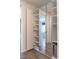 Spacious walk-in closet boasts ample shelving and a mirrored door to adjoining room at 103 Inara Ct, Carrboro, NC 27510