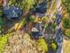 Birds eye view of a home with a dark roof surrounded by mature trees and greenery at 109 Hardee St, Clayton, NC 27520