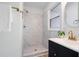 Stylish bathroom showcasing a tiled walk-in shower, modern vanity, and elegant gold fixtures at 109 Hardee St, Clayton, NC 27520