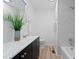 Bright bathroom featuring marble-look tile, a modern vanity, and stylish fixtures create a clean and inviting space at 109 Hardee St, Clayton, NC 27520