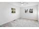 Bright bedroom featuring two windows and carpeted floors, providing a light and airy space at 109 Hardee St, Clayton, NC 27520