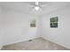 Well-lit bedroom featuring plush carpet and double windows with views at 109 Hardee St, Clayton, NC 27520