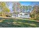 Single-story home has a well maintained lawn and white painted brick exterior walls at 109 Hardee St, Clayton, NC 27520