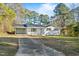 Single story home with a long concrete driveway, lush lawn and white painted brick at 109 Hardee St, Clayton, NC 27520