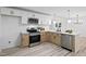 Modern kitchen featuring stainless steel appliances, white countertops, and two-tone cabinets at 109 Hardee St, Clayton, NC 27520