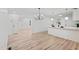 Open-concept living area with wood-look floors and a modern kitchen view at 109 Hardee St, Clayton, NC 27520