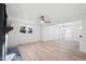 Open floor plan living room with lots of light, hardwood floor, and stylish fireplace at 109 Hardee St, Clayton, NC 27520