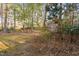 Backyard with a wooded backdrop features mature trees, and natural foliage at 1201 Deerfield Dr, Cary, NC 27511