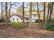 Spacious backyard view of home featuring a white deck and partial wood fencing at 1201 Deerfield Dr, Cary, NC 27511