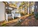Backyard of home featuring a wood deck, patio, and mature trees at 1201 Deerfield Dr, Cary, NC 27511