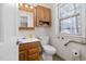 Cozy bathroom with oak cabinets, white sink, and accessibility bars, offering comfort and practicality at 1201 Deerfield Dr, Cary, NC 27511