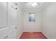 Small bedroom featuring a window with blinds, neutral paint, and red carpet at 1201 Deerfield Dr, Cary, NC 27511