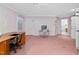 Spacious bedroom with neutral carpet and paint, featuring a desk and office chair at 1201 Deerfield Dr, Cary, NC 27511