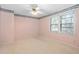 Well-lit bedroom features a ceiling fan and large windows with natural light at 1201 Deerfield Dr, Cary, NC 27511