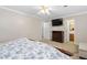 Comfortable bedroom featuring neutral walls, carpet, a ceiling fan, and a mounted television for relaxation at 1201 Deerfield Dr, Cary, NC 27511