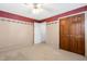 Carpeted bedroom with neutral decor, ceiling fan, and closet space at 1201 Deerfield Dr, Cary, NC 27511