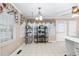 Bright breakfast nook featuring floral curtains, white tile floor, and access to the backyard at 1201 Deerfield Dr, Cary, NC 27511