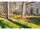 Lush front yard showcases a classic brick home with mature trees at 1201 Deerfield Dr, Cary, NC 27511