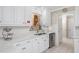 Bright kitchen with white cabinetry, stainless steel appliances, and stylish backsplash for a modern touch at 1201 Deerfield Dr, Cary, NC 27511