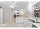 Open-concept kitchen offering white cabinets and stainless steel sink, with an island at 1201 Deerfield Dr, Cary, NC 27511
