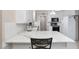 Bright kitchen with white cabinets, marble countertops, stainless steel appliances, and a stylish backsplash at 1201 Deerfield Dr, Cary, NC 27511