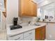 Kitchen counter area featuring a coffee maker and view into the bright, white kitchen at 1201 Deerfield Dr, Cary, NC 27511